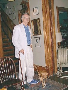 a guy and a cane and a dog