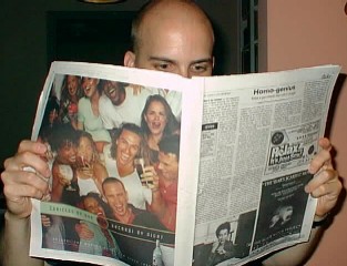 Brett reading an Atlanta newspaper in July 99