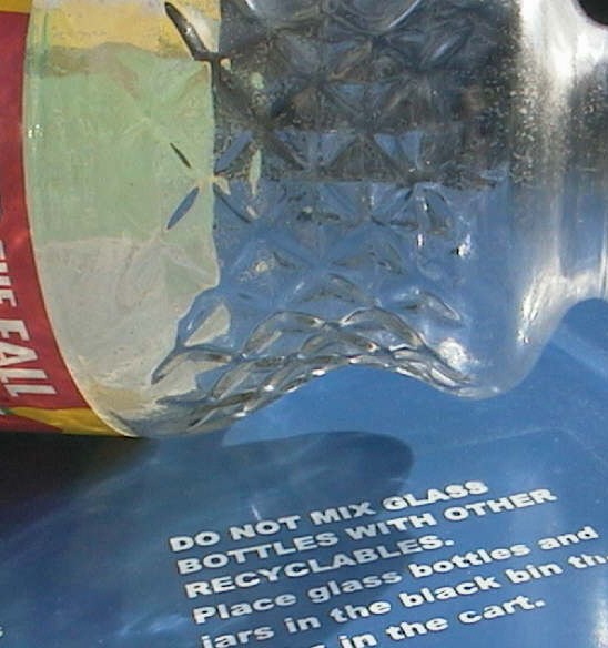 glass bottle on the recycle bin