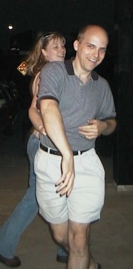 Brett dancing with Bethany in front of a shoe store
