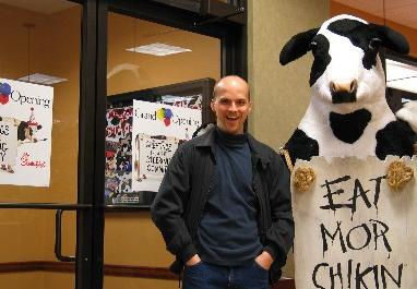 Brett and the Chick Fil A cow mascot at the grand opening