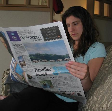 Ariana reading the paper in our hotel suite