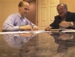 Brett signs refinancing papers